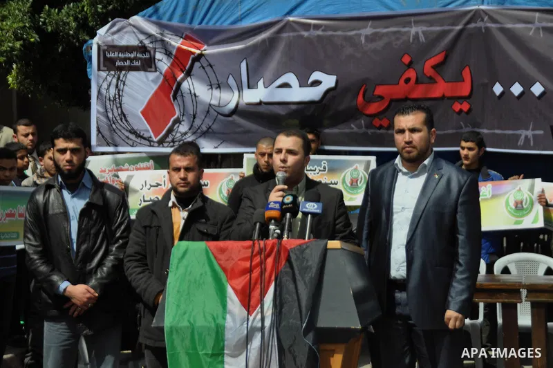 Palestinian protesters take part in a demonstration against the Egyptian-Israeli blockade on Gaza Strip, in Gaza City on March 16, 2014. Photo by Mohammed Talatene
