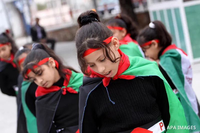 Palestinian girls take part in a rally to show solidarity with Palestinian refugees Syria's main refugee camp Yarmouk, in Gaza City on March 17, 2014. Photo by Mohammed Asad