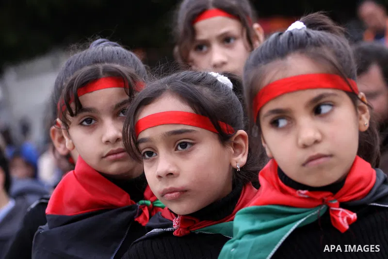 Palestinian girls take part in a rally to show solidarity with Palestinian refugees Syria's main refugee camp Yarmouk, in Gaza City on March 17, 2014. Photo by Mohammed Asad
