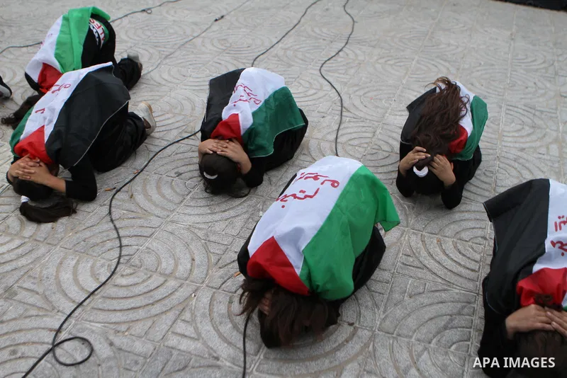 Palestinian girls take part in a rally to show solidarity with Palestinian refugees Syria's main refugee camp Yarmouk, in Gaza City on March 17, 2014. Photo by Mohammed Asad