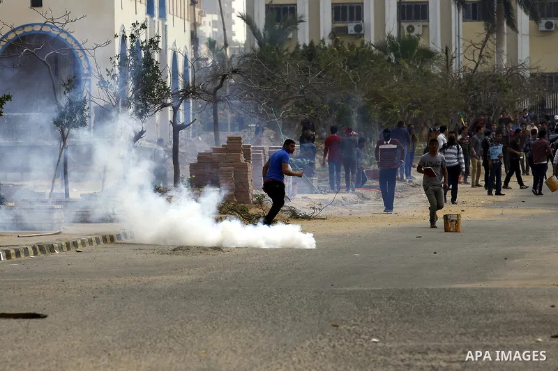 Egyptian students of al-Azhar University who are supporters of the Muslim Brotherhood and ousted Egyptian President Mohamed Mursi, throw stones at riot police during clashes in Cairo's Nasr City district, March 19, 2014....