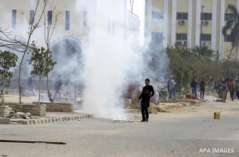 Egyptian students of al-Azhar University who are supporters of the Muslim Brotherhood and ousted Egyptian President Mohamed Mursi, throw stones at riot police during clashes in Cairo's Nasr City district, March 19, 2014....