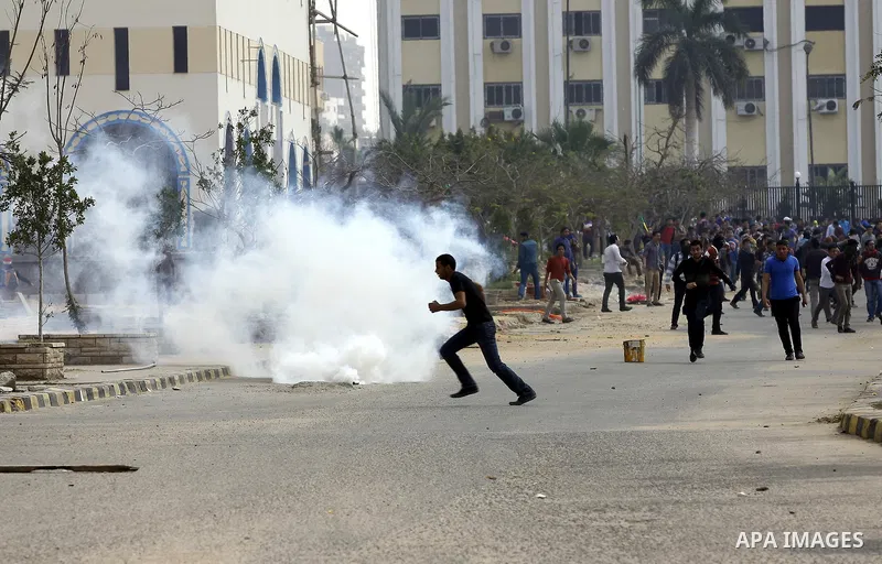 Egyptian students of al-Azhar University who are supporters of the Muslim Brotherhood and ousted Egyptian President Mohamed Mursi, throw stones at riot police during clashes in Cairo's Nasr City district, March 19, 2014....