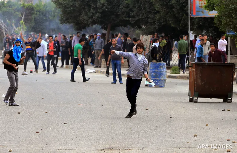 Egyptian students of al-Azhar University who are supporters of the Muslim Brotherhood and ousted Egyptian President Mohamed Mursi, throw stones at riot police during clashes in Cairo's Nasr City district, March 19, 2014....