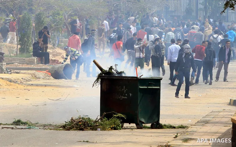 Egyptian students of al-Azhar University who are supporters of the Muslim Brotherhood and ousted Egyptian President Mohamed Mursi, throw stones at riot police during clashes in Cairo's Nasr City district, March 19, 2014....