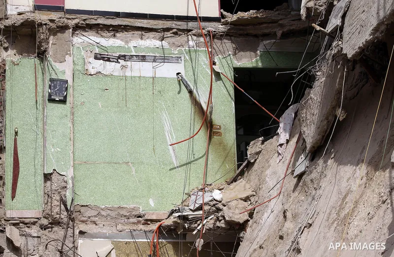 The remains of a collapsed building is seen in Cairo's Nasr City district, March 19, 2014. The facade of a six-story building has collapsed near the headquarters of the Egyptian Air Force, while casualty numbers are as y...