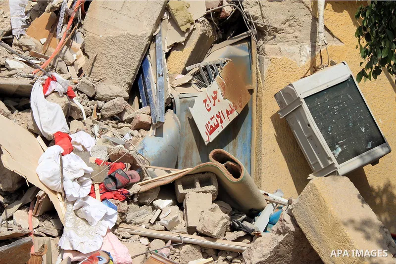 The remains of a collapsed building is seen in Cairo's Nasr City district, March 19, 2014. The facade of a six-story building has collapsed near the headquarters of the Egyptian Air Force, while casualty numbers are as y...