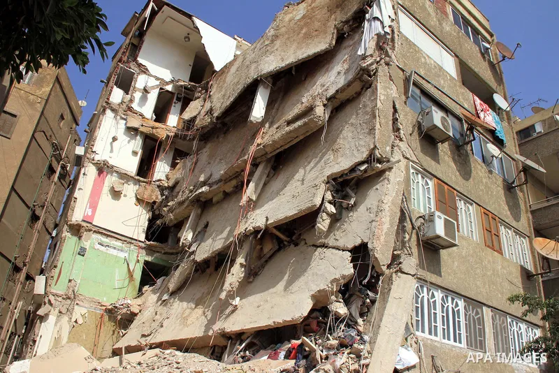 The remains of a collapsed building is seen in Cairo's Nasr City district, March 19, 2014. The facade of a six-story building has collapsed near the headquarters of the Egyptian Air Force, while casualty numbers are as y...