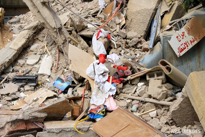 The remains of a collapsed building is seen in Cairo's Nasr City district, March 19, 2014. The facade of a six-story building has collapsed near the headquarters of the Egyptian Air Force, while casualty numbers are as y...