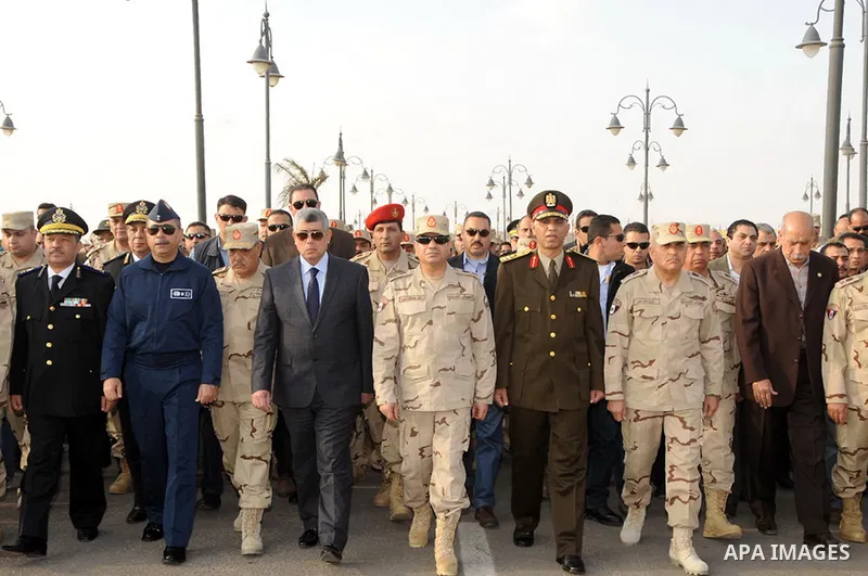 A handout picture released by the military moral affairs shows the Egypt's army chief, Field Marshal Abdel Fattah al-Sisi, attends the funeral of two army officers killed by a militant group, in Cairo on March 19, 2014....