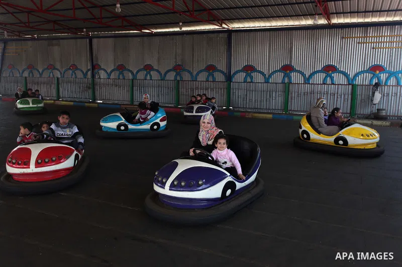 Palestinian children and their families enjoy a day at an amusement park on the eve of the Mother's Day, in Gaza City March 20, 2014. Photo by Ashraf Amra