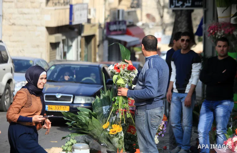 A Palestinian vendor displays flowers outside his store on the eve of the Mother's Day, in Jerusalem March 20, 2014. Photo by Saeed Qaq
