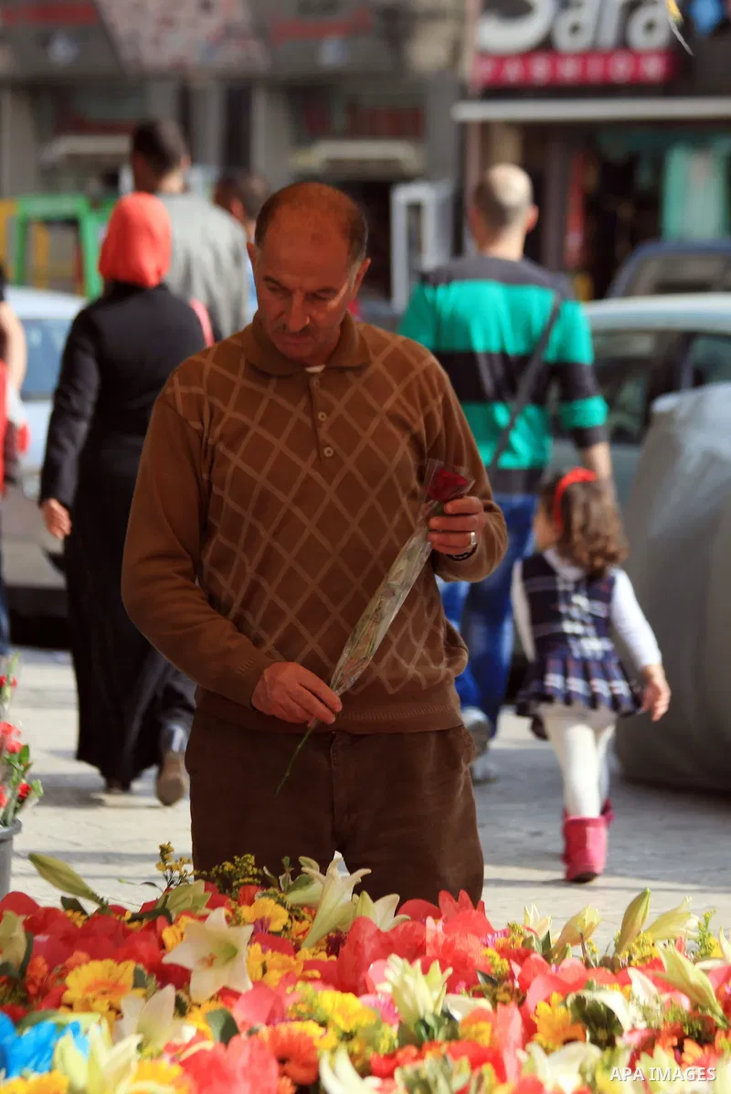 A Palestinian man buys flowers on the eve of the Mother's Day, in Jerusalem March 20, 2014. Photo by Saeed Qaq