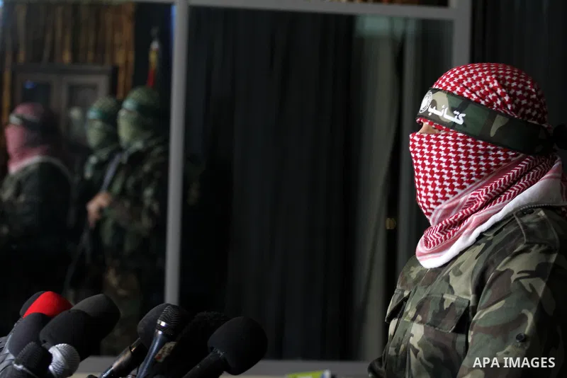 Palestinian militants of the Hamas' armed wing, Ezzeddine al-Qassam Brigades, attend a press conference in Gaza City, March 20, 2014. A tunnel that was uncovered by the IDF between Gaza Strip and Israel was destroyed twi...