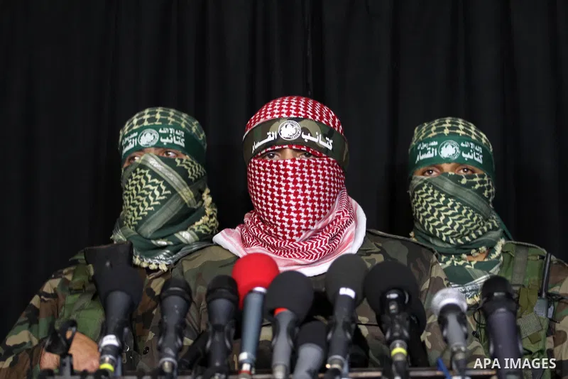 Palestinian militants of the Hamas' armed wing, Ezzeddine al-Qassam Brigades, attend a press conference in Gaza City, March 20, 2014. A tunnel that was uncovered by the IDF between Gaza Strip and Israel was destroyed twi...