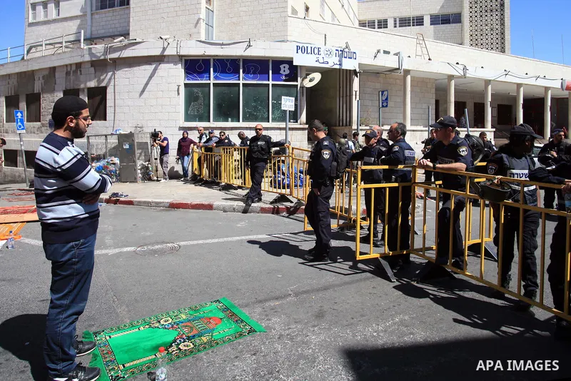 Palestinian Muslims pray outside of the Old City of Jerusalem as Israeli police block them from praying in the city's Al-Aqsa mosque, in the Ras Al-Amud neighborhood of East Jerusalem on 21 March 2014. Israel restricted...