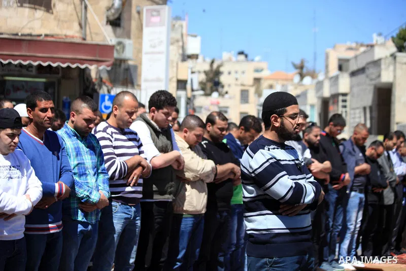 Palestinian Muslims pray outside of the Old City of Jerusalem as Israeli police block them from praying in the city's Al-Aqsa mosque, in the Ras Al-Amud neighborhood of East Jerusalem on 21 March 2014. Israel restricted...