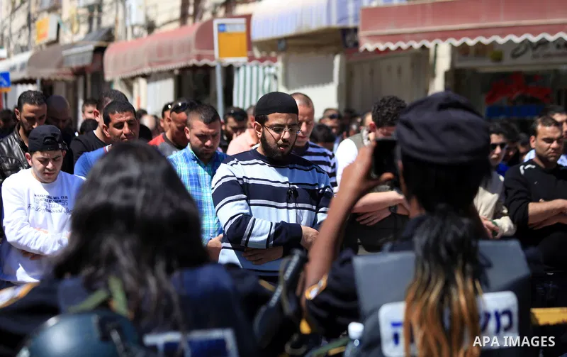Palestinian Muslims pray outside of the Old City of Jerusalem as Israeli police block them from praying in the city's Al-Aqsa mosque, in the Ras Al-Amud neighborhood of East Jerusalem on 21 March 2014. Israel restricted...