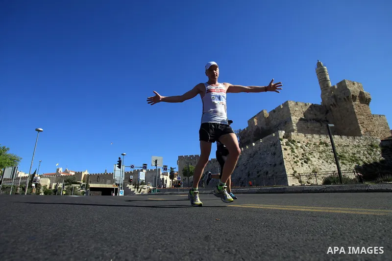 Local and international runners take part in the annual Jerusalem Marathon in the Old City on March 21, 2014. More than 15,000 runners from 50 different countries participated in the annual sporting event included runnin...