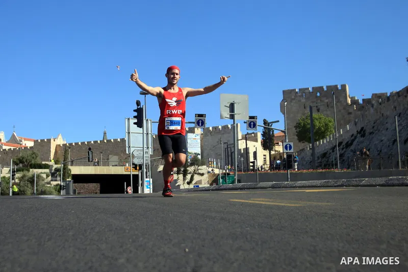 Local and international runners take part in the annual Jerusalem Marathon in the Old City on March 21, 2014. More than 15,000 runners from 50 different countries participated in the annual sporting event included runnin...
