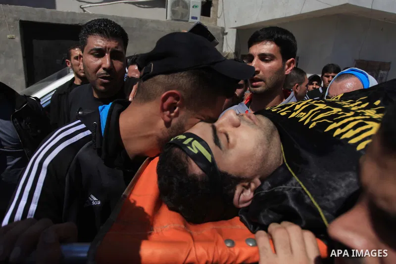 Palestinians carry tthe bodies of the three Palestinians during their funeral in the West Bank refugee camp of Jenin on Saturday, March 22, 2014. Israeli troops killed at least three Palestinians in an early morning raid...