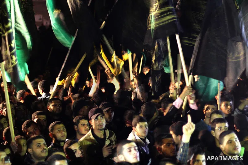 Palestinian supporters of Hamas and Jihad Islamic movements chant slogans during a protest in Gaza City on March 22, 2014 against the killing of three Palestinians were killed in Jenin refugee camp in the West Bank durin...
