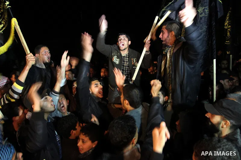 Palestinian supporters of Hamas and Jihad Islamic movements chant slogans during a protest in Gaza City on March 22, 2014 against the killing of three Palestinians were killed in Jenin refugee camp in the West Bank durin...