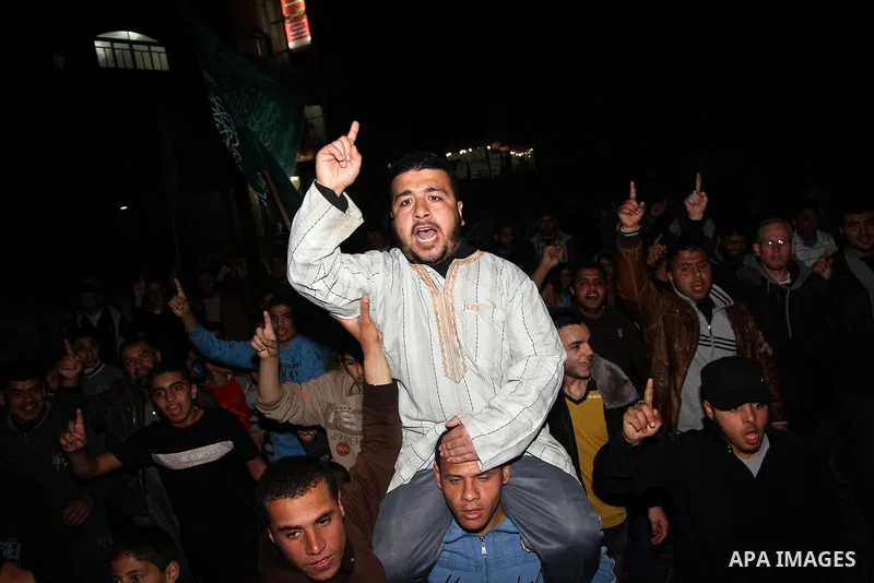 Palestinian supporters of Hamas and Jihad Islamic movements chant slogans during a protest in Gaza City on March 22, 2014 against the killing of three Palestinians were killed in Jenin refugee camp in the West Bank durin...