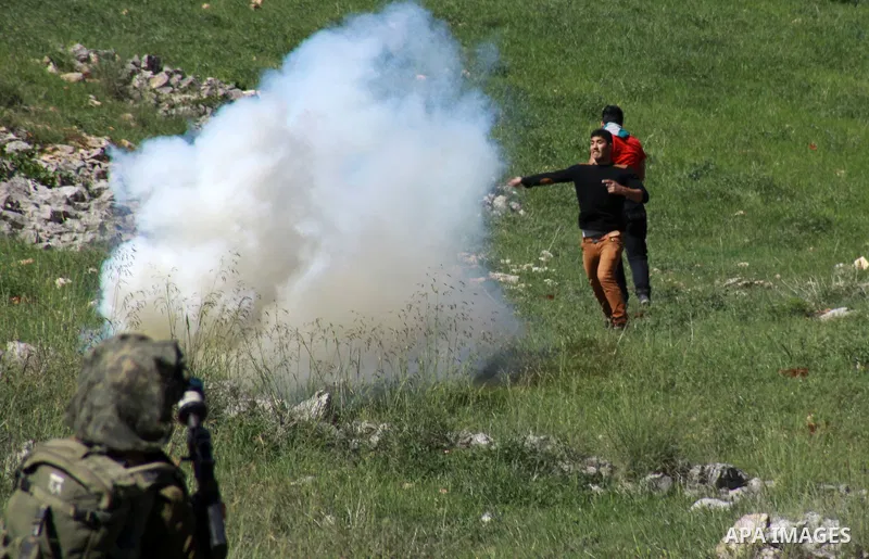 Palestinian protesters throw stones at Israeli security forces during clashes in the West Bank village of Burin on March 28, 2014. Israel has told the Palestinians it will not free the final batch of prisoners they had b...