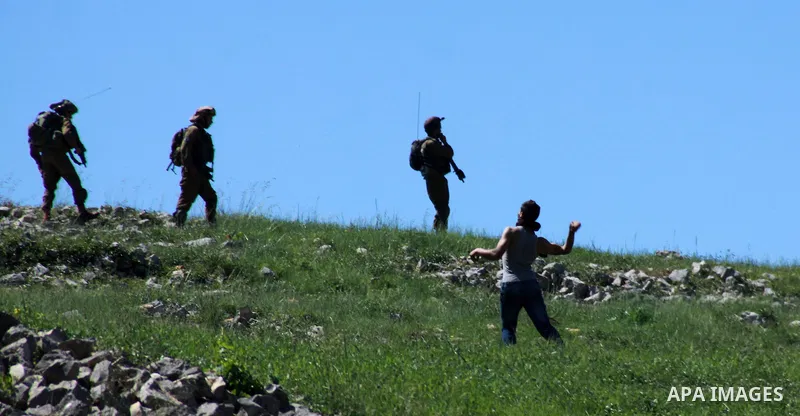 A Palestinian protester throws stones at Israeli security forces during clashes in the West Bank village of Burin on March 28, 2014. Israel has told the Palestinians it will not free the final batch of prisoners they had...