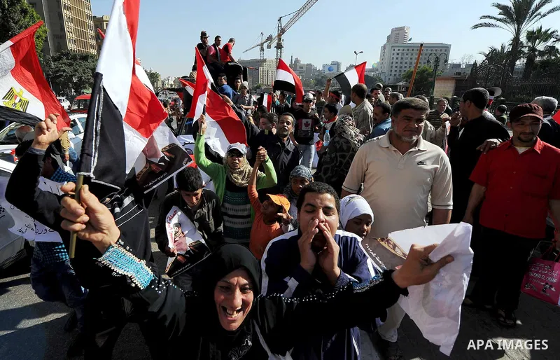 Egyptian supporter of Former Egyptian military chief and presidential candidate Abdel-Fattah el-Sisi, hold his pictures during a rally to support him in Cairo on March 28, 2014. Al-Sisi announced on Wednesday his preside...
