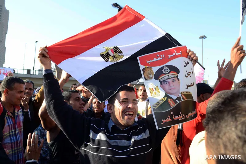 Egyptian supporter of Former Egyptian military chief and presidential candidate Abdel-Fattah el-Sisi, hold his pictures during a rally to support him in Cairo on March 28, 2014. Al-Sisi announced on Wednesday his preside...