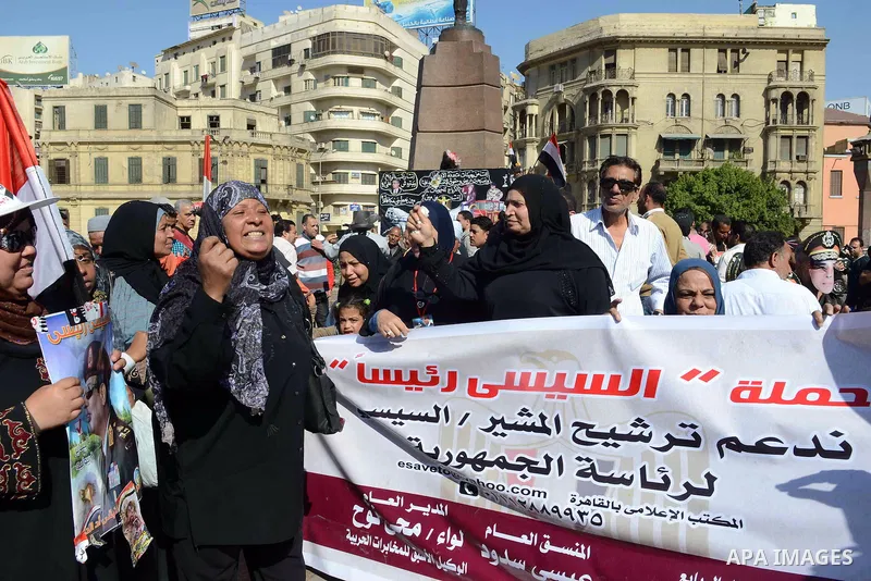 Egyptian supporter of Former Egyptian military chief and presidential candidate Abdel-Fattah el-Sisi, hold his pictures during a rally to support him in Cairo on March 28, 2014. Al-Sisi announced on Wednesday his preside...