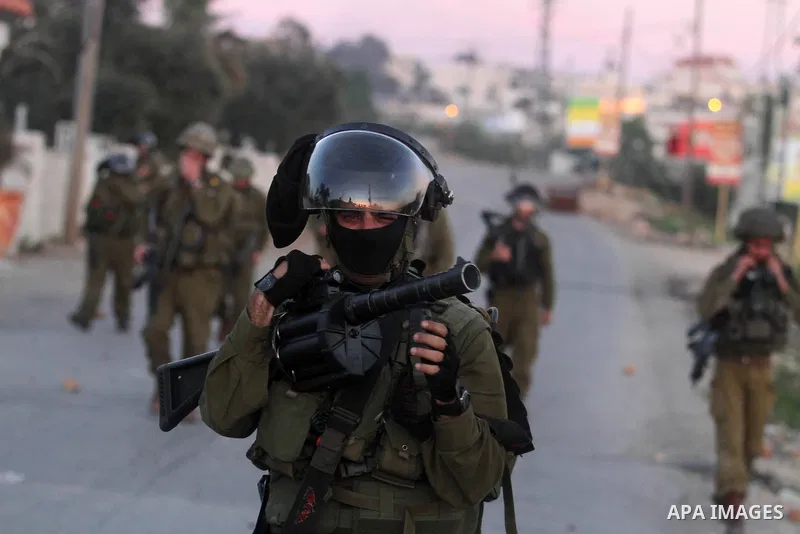 Israeli security forces take position during clashes with Palestinian protesters in the West Bank village of Silwad, north of Ramallah, on March 28, 2014 following a protest of Palestinians against the expansion of the n...