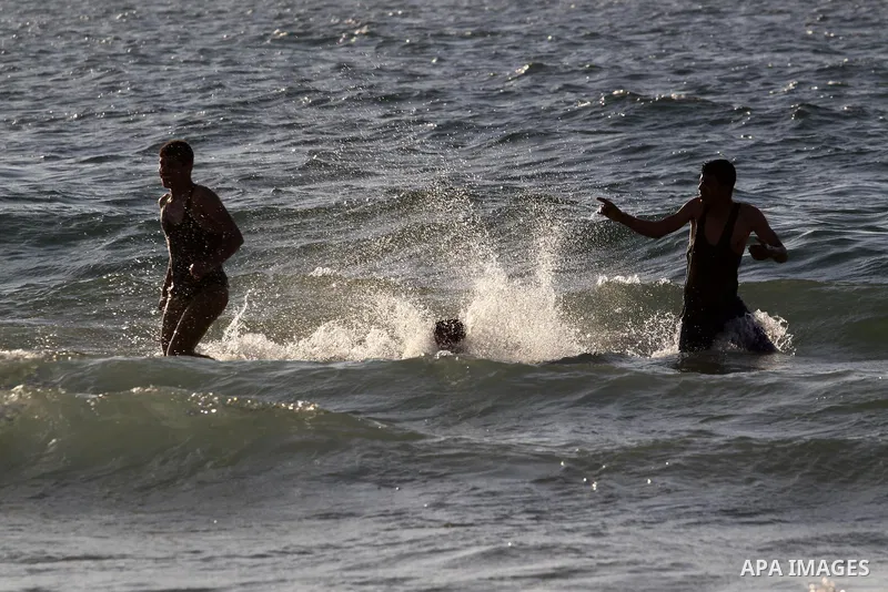 Palestinians enjoy swimming during a hot weather at the beach of Gaza city, on March 28, 2014. Photo by Mohammed Asad