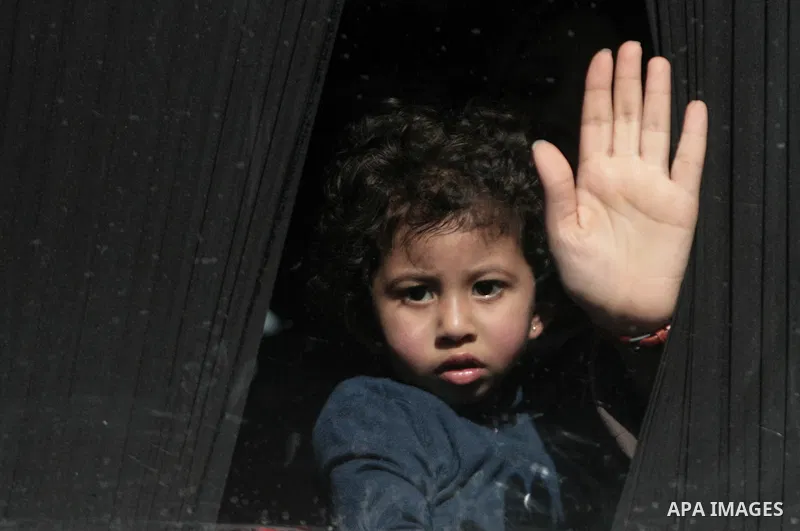 A Palestinian girl hoping to cross into Egypt waits inside a bus at the Rafah crossing between Egypt and the southern Gaza Strip March 29, 2014. Egyptian authorities partially reopened Rafah border crossing, Gaza's main...