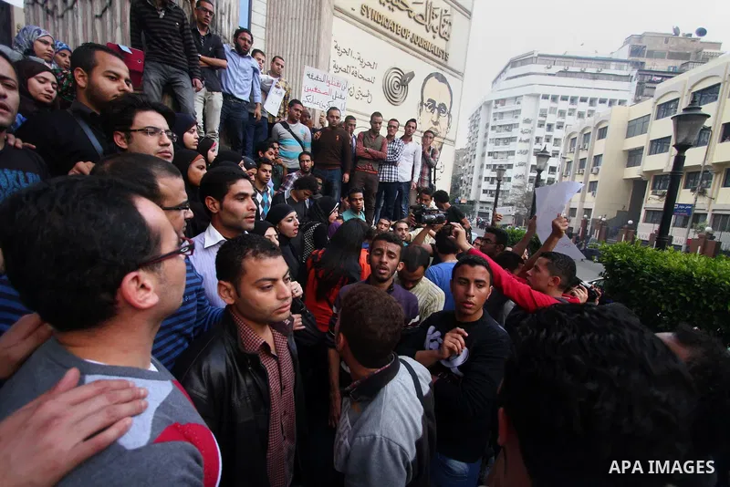 Egyptian journalists hold banners during a protest the death of the Egyptian journalist Mayada Ashraf, outside the Egyptian Journalist Syndicate in Cairo, on March 29, 2014. Al-Dustour, a privately-owned newspaper, said...
