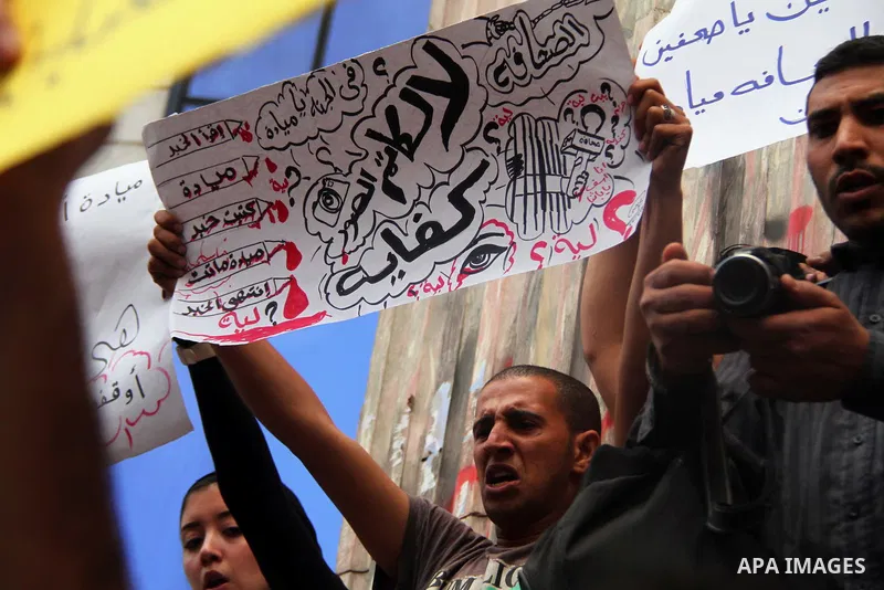 Egyptian journalists hold banners during a protest the death of the Egyptian journalist Mayada Ashraf, outside the Egyptian Journalist Syndicate in Cairo, on March 29, 2014. Al-Dustour, a privately-owned newspaper, said...