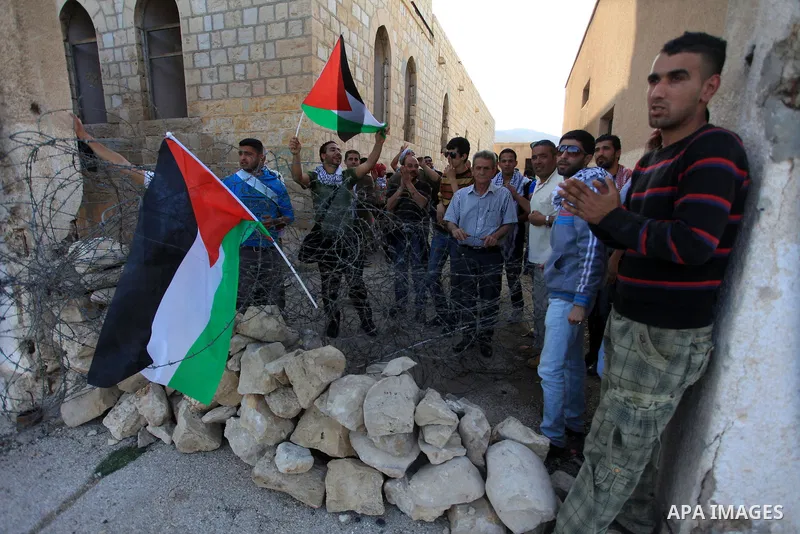 Palestinian and foreign activists during protest in Bawaba Karama Village, near of the West Bank City of Jericho March 29, 2014. Hundreds of Palestinians announced campaign Building the village of Bawaba Karama marking t...