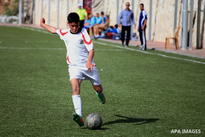 Palestinian Local players play with wahdat sport club from Jordan during their match, at Jerusalem city, on March 29, 2014. Palestinian Sakhnin players win in the International Cup of Jerusalem. Photo by Saeed Qaq