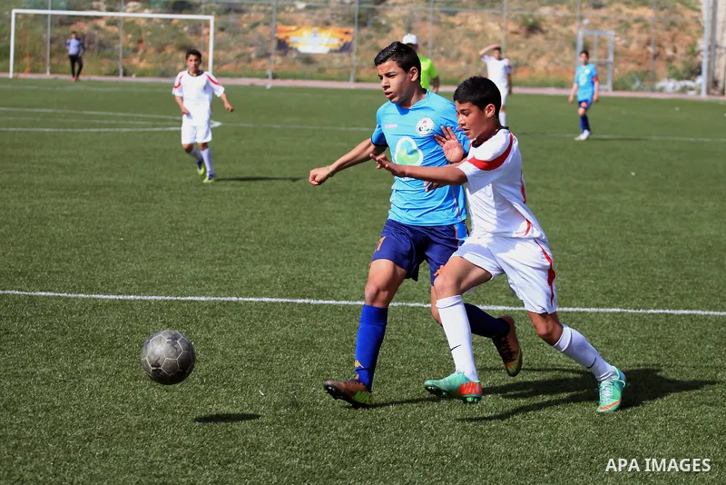 Palestinian Local players play with wahdat sport club from Jordan during their match, at Jerusalem city, on March 29, 2014. Palestinian Sakhnin players win in the International Cup of Jerusalem. Photo by Saeed Qaq