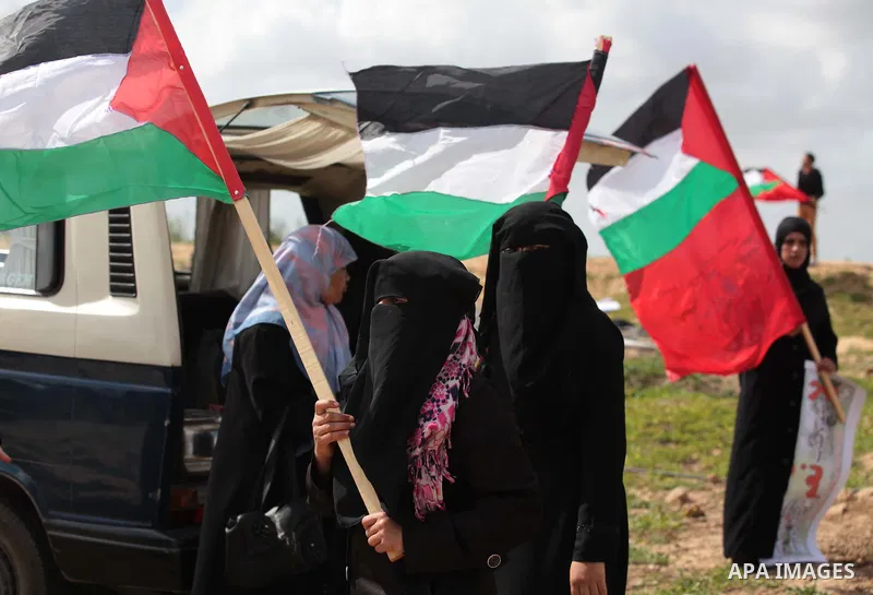 Palestinian supporters of the Popular Front for the Liberation of Palestine hold national flags during a rally marking Land Day in Jabalya in the northern Gaza Strip on March 30, 2014. The annual demonstrations mark the...