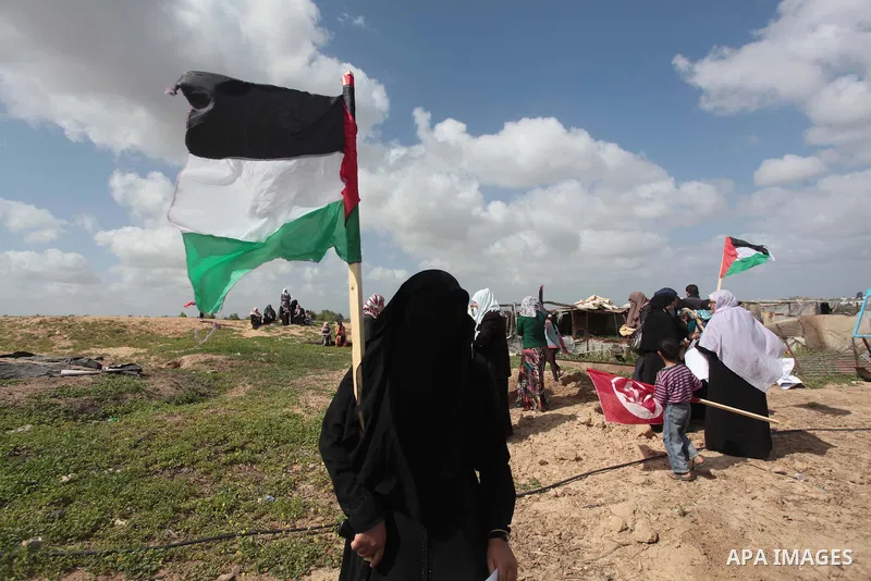 Palestinian supporters of the Popular Front for the Liberation of Palestine hold national flags during a rally marking Land Day in Jabalya in the northern Gaza Strip on March 30, 2014. The annual demonstrations mark the...