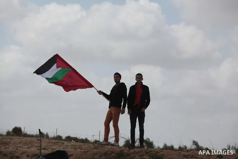 Palestinian supporters of the Popular Front for the Liberation of Palestine hold national flags during a rally marking Land Day in Jabalya in the northern Gaza Strip on March 30, 2014. The annual demonstrations mark the...