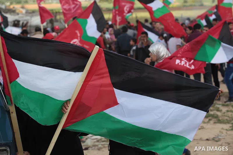 Palestinian supporters of the Popular Front for the Liberation of Palestine hold national flags during a rally marking Land Day in Jabalya in the northern Gaza Strip on March 30, 2014. The annual demonstrations mark the...