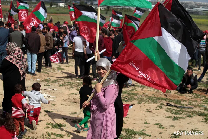Palestinian supporters of the Popular Front for the Liberation of Palestine hold national flags during a rally marking Land Day in Jabalya in the northern Gaza Strip on March 30, 2014. The annual demonstrations mark the...