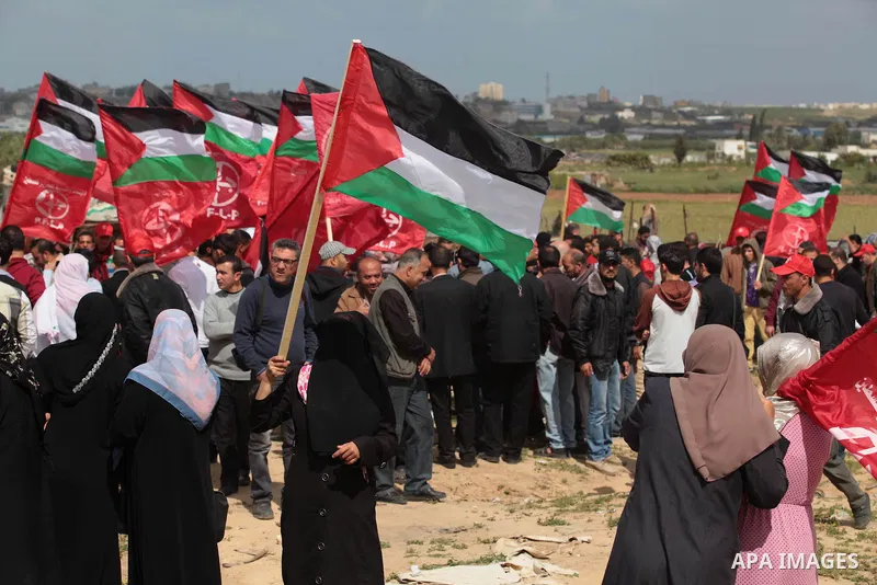 Palestinian supporters of the Popular Front for the Liberation of Palestine hold national flags during a rally marking Land Day in Jabalya in the northern Gaza Strip on March 30, 2014. The annual demonstrations mark the...