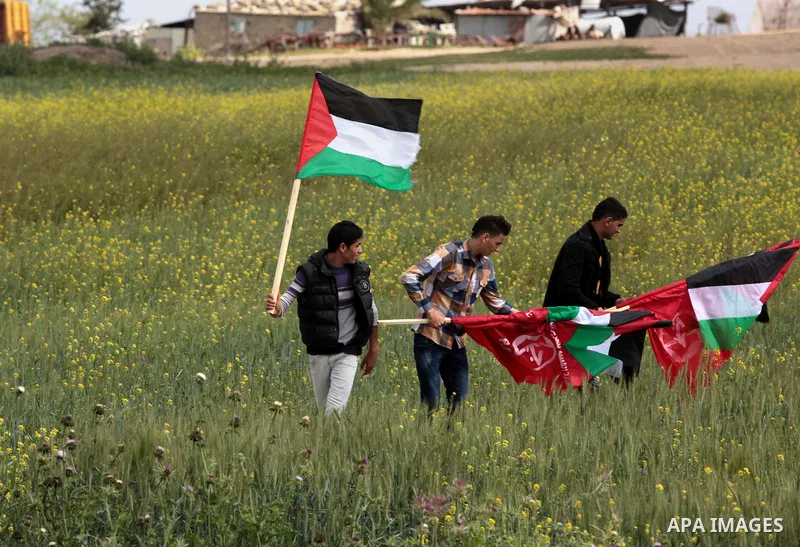 Palestinian supporters of the Popular Front for the Liberation of Palestine hold national flags during a rally marking Land Day in Jabalya in the northern Gaza Strip on March 30, 2014. The annual demonstrations mark the...