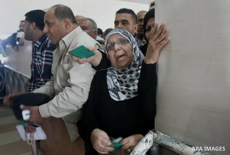 Palestinians wait to cross into Egypt at the Rafah border crossing between Egypt and the southern Gaza Strip on March 30, 2014. The Gaza Strip's land border with Egypt reopened after a 50-day closure, but only for three...