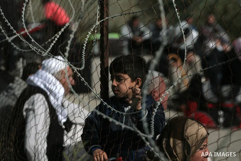 Palestinians wait to cross into Egypt at the Rafah border crossing between Egypt and the southern Gaza Strip on March 30, 2014. The Gaza Strip's land border with Egypt reopened after a 50-day closure, but only for three...